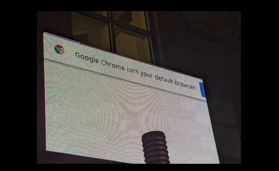 photo of a screen on the street reading "Google Chrome isn't your default browser"